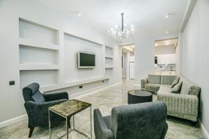 a living room with couches and a tv at Lux Apartment View Baku Formula 1 Street in Baku