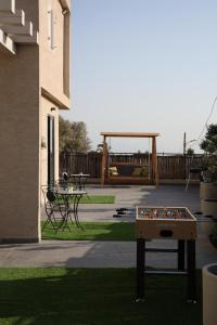 a ping pong table in the middle of a yard at מעגל השמש in Poriyya Illit