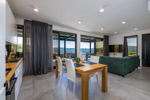 a kitchen and living room with a table and chairs at Villa with Private Pool & Lake View near Motovun, Casa Mille Olivi Modern in Buzet