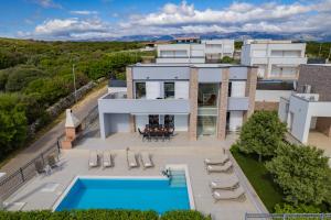 an aerial view of a house with a swimming pool at Villas Royal III in Novalja