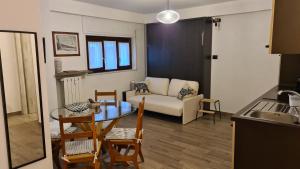 a living room with a table and a couch at Monolocale Sauze d'Oulx in Sauze dʼOulx