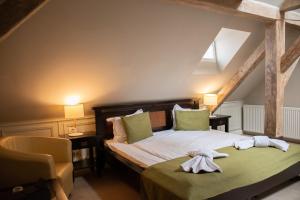 a bedroom with a bed and a chair at Hirscher Loft in Braşov