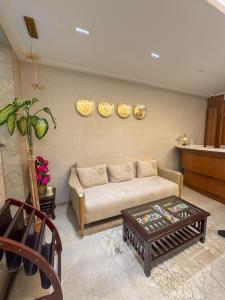 a living room with a couch and a table at The Fortunaa Avenue in Gwalior +2 photos