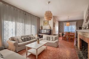 a living room with a couch and a fireplace at Tordera Village in Tordera