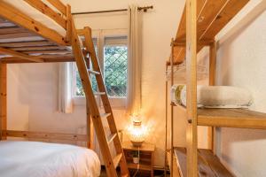 a bedroom with two bunk beds and a window at Tordera Village in Tordera +24 photos