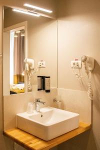 a bathroom with a sink and a mirror at Hirscher Loft in Braşov +22 photos