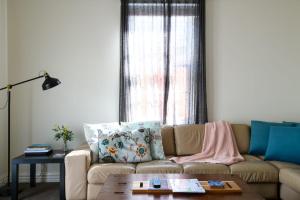 ein Wohnzimmer mit Sofa und Tisch in der Unterkunft Heritage Cottage Daylesford in Daylesford