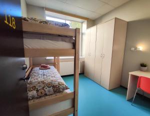 タリンにあるTallinn Airport Stayの二段ベッド2台とテーブルのある部屋