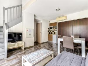 a living room with a bed and a dining room at Vacancéole - Les Demeures Torrellanes - Saint-Cyprien in Saint-Cyprien