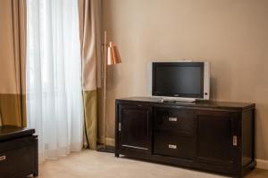 a tv sitting on top of a dresser in a room at Hirscher Loft in Braşov