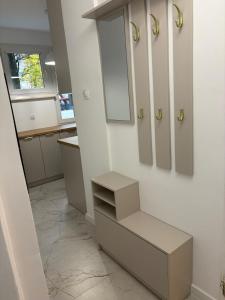 a bathroom with a sink and a drawer and a mirror at MW Leo Apartament in Konin +2 photos