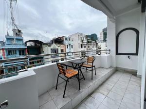 a balcony with two chairs and a table on it at Spotlight Hotel in Ho Chi Minh City