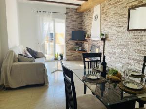 a living room with a table with chairs and a couch at Casa Blanca con vistas by At Home Costa del in Torrox Costa +45 photos