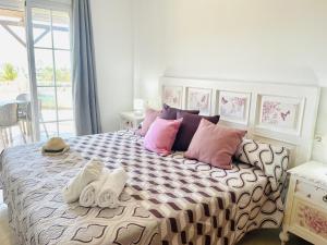 a bedroom with a large bed with towels on it at Casa Blanca con vistas by At Home Costa del in Torrox Costa