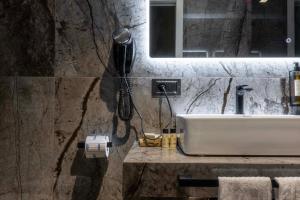 a bathroom with a sink and a phone on the wall at Home at Rome Luxury Navona Guesthouse in Rome +93 photos