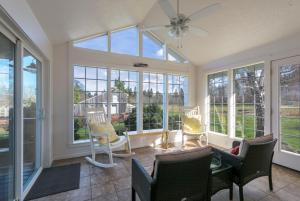 a screened in porch with chairs and windows at Quail On Sunset in Hood River