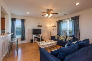 a living room with a blue couch and a table at Sandy Hook in Galveston