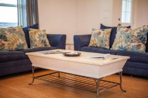a living room with a coffee table and couches at Sandy Hook in Galveston
