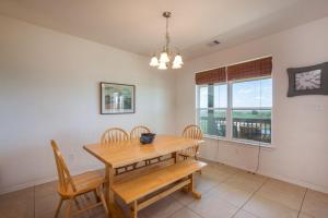 a dining room with a wooden table and chairs at Sandy Hook in Galveston +38 photos