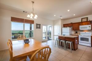 a kitchen with a wooden table and a dining room at Sandy Hook in Galveston