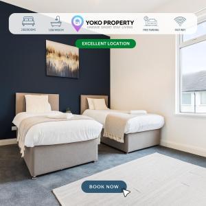 two beds in a room with a sign that reads javascript location at Herschell House - Central Location - Free Parking, Fast Wifi, SmartTV with Netflix - Perfect for Contractors, Families and Groups by Yoko Property in Redcar