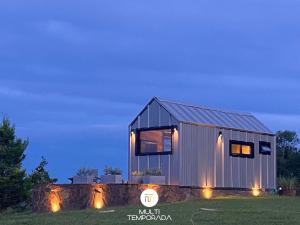 a tiny house on a stone wall at night at Via Kairós - Rancho Queimado - SC in Rancho Queimado