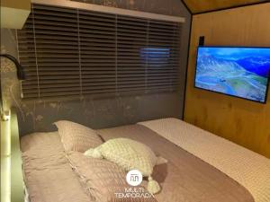 a bedroom with a bed with a teddy bear on it at Via Kairós - Rancho Queimado - SC in Rancho Queimado +90 photos