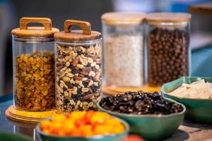 a group of jars filled with different types of food at Hotel Palma Avenidas in Palma de Mallorca