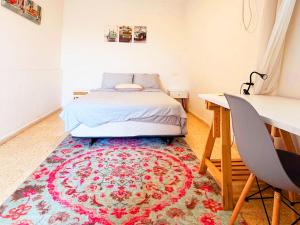 a bedroom with a bed and a rug at Spacious 3BD Penthouse with Rooftop & Parking in Ra‘ananna