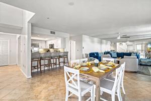 a dining room and living room with a table and chairs at Bayside Escape - 1345 in Siesta Key