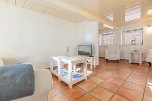 a living room with a couch and a table at Reethus Humptrup in Humptrup