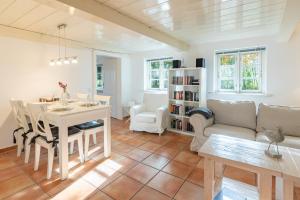 a living room with a table and a dining room at Reethus Humptrup in Humptrup