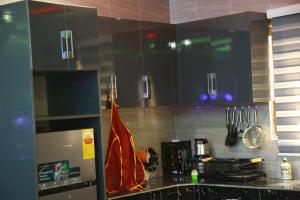a kitchen with black cabinets and a counter top at Erliz villa in Kumasi