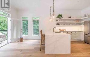 - une cuisine avec des murs blancs et un comptoir blanc dans l'établissement Family friendly place with pool and jacuzzi, à Penetanguishene