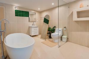 a bathroom with a tub and a toilet and a sink at Tulum Villa Resort Koh Samui in Bophut  +86 photos