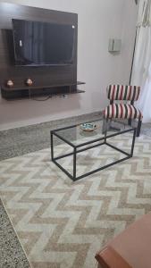 a living room with a chair and a glass coffee table at Mejor zona de Paraná in Paraná