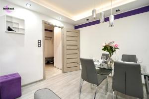 a dining room with a table and chairs at MMRent Apartament CityLight in Gdańsk