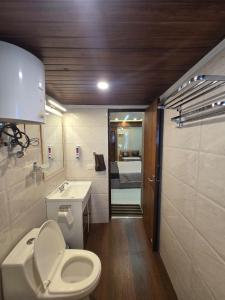 a small bathroom with a toilet and a sink at Cozy Studio in Ghaziabad