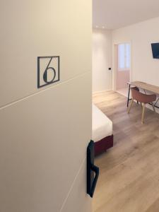 a bedroom with a bed and a desk in a room at Dimora in Prato in Padova