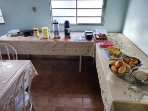 a room with two tables with food on it at Pousada Rezende in Caldas Novas +17 photos