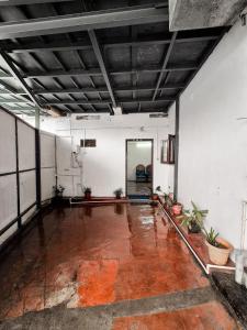 an empty room with a large room with plants at White stays in Munnar