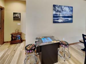 a room with two stools and a table with a laptop at Mountain Whisper in McHenry