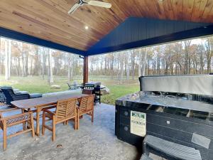 a patio with a grill and a table and chairs at Mountain Whisper in McHenry