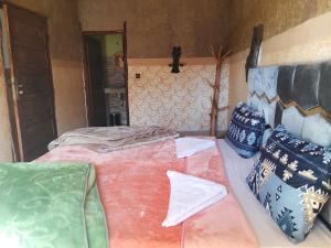 a bedroom with two beds and pillows at riad atlas imnane in Imlil