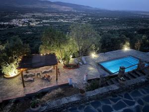 an overhead view of a swimming pool at night at Casa Rural La Cordonera in Herguijuela