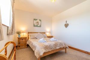 TalsarnauにあるBeudy-Talsarnauのベッドとタオル2枚のある寝室