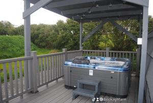 a hot tub on the deck of a house at Bockagh Farm in Ballaghaderreen