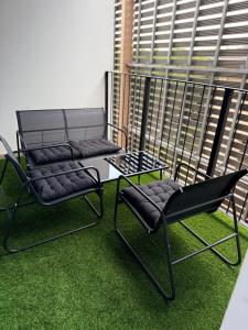 two chairs and a table and a chair on a balcony at LiFa Luxury Sandton Retreat in Johannesburg