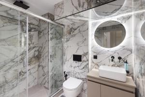 a bathroom with a shower and a toilet and a sink at Amelie Studios by halu! in Thessaloniki