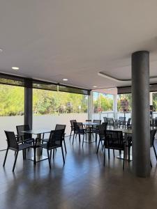 a dining area with tables and chairs in a building at Hotel 170 in Castelldefels